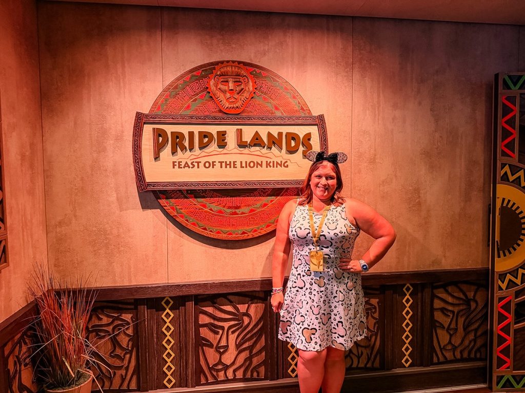 Pride Lands Feast of the Lion King Outfit Near Entrance Sign